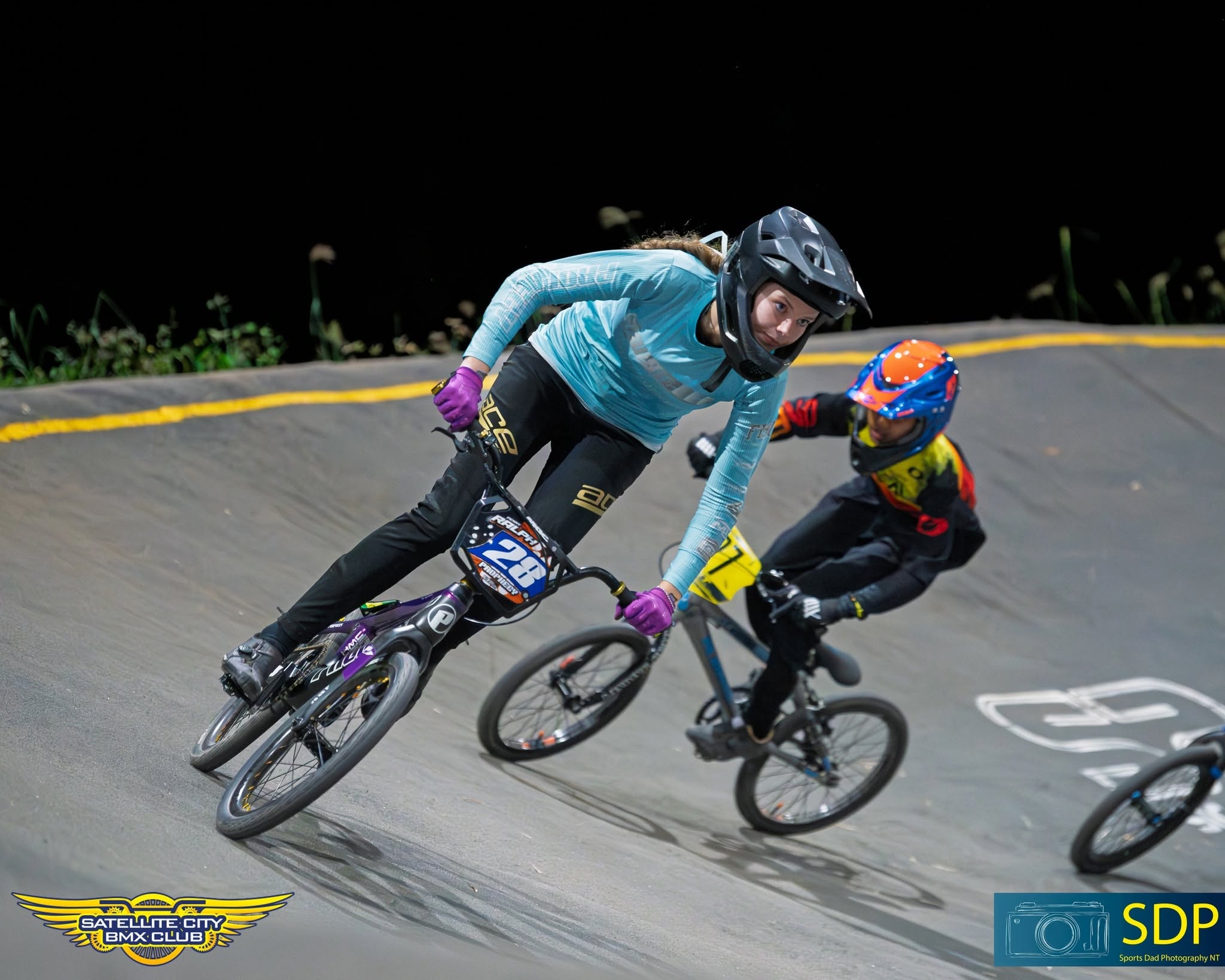 Girl rider #188 in USA jersey on teal and purple bike